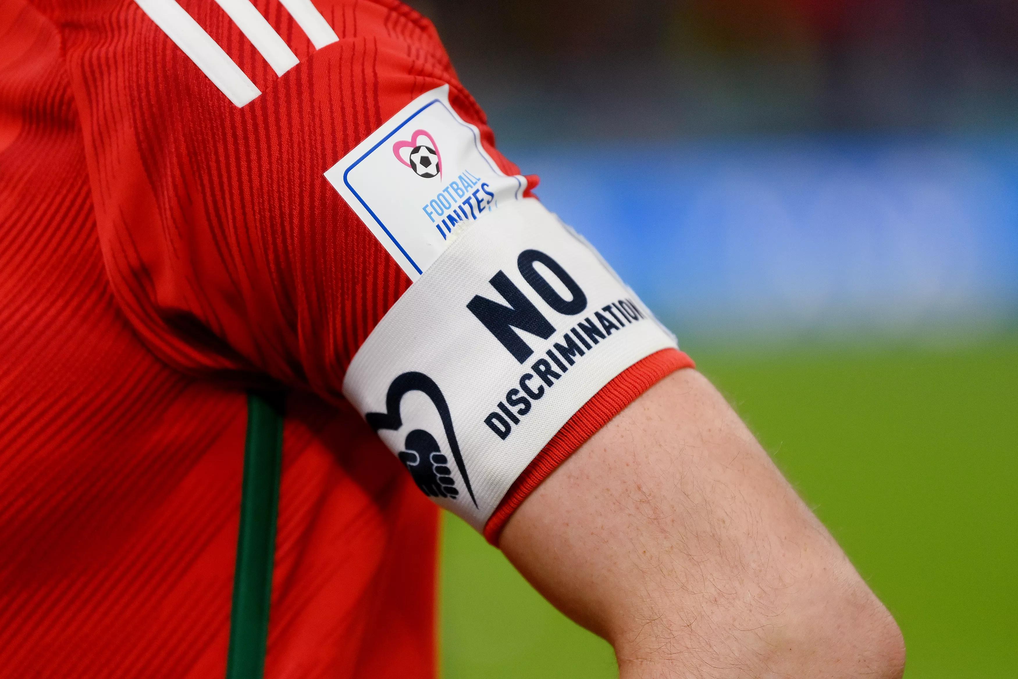 DOHA, QATAR - NOVEMBER 21: Detail of the No Discrimination captain's armband of Gareth Bale of Wales during the FIFA World Cup Qatar 2022 Group B match between USA and Wales at Ahmad Bin Ali Stadium on November 21, 2022 in Doha, Qatar. (Photo by David Ramos - FIFA/FIFA via Getty Images)